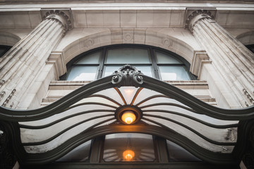 Facade of a building with columns above a canopy at the entrance of a building - New York City, NY