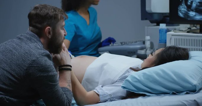 Doctor examining pregnant woman with ultrasound