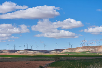 Landscape of windmills in spring with fields full of brown and green colors
