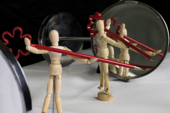 Mannequin in plastic pose in front of the mirror performs gymnastic exercises - still life