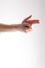 Vertical image of two hands splice in be shape of the gun on white background.