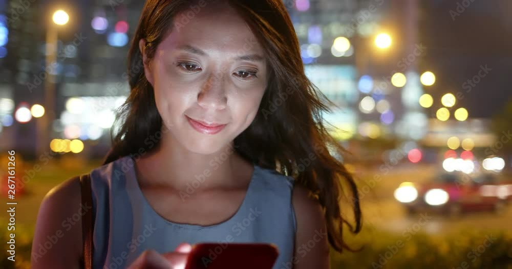 Canvas Prints Woman use of smart phone in city at night