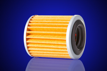 Car filter microfiber paper for cleaning lye on its side with reflection, isolated spare part on a gradient blue to black background with.