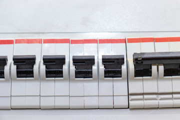 Row of automatic switches of electricity in the electrical shield in the house close up
