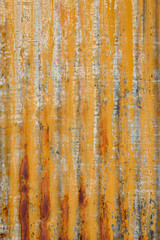 Rusty sheet of corrugated metal wall, as an orange textured background