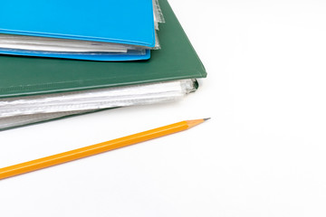Cropped colorful folders with documents and bills and a yellow pencil on white table with copy space