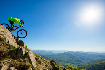 Man on mountain bike rides on a beautiful rocky trail