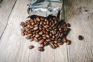 Roasted coffee beans against wooden background