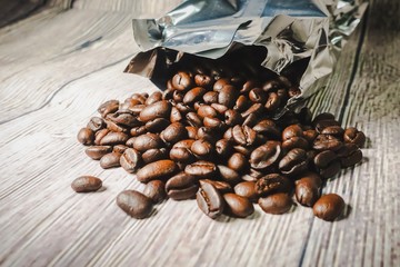 Roasted coffee beans against wooden background