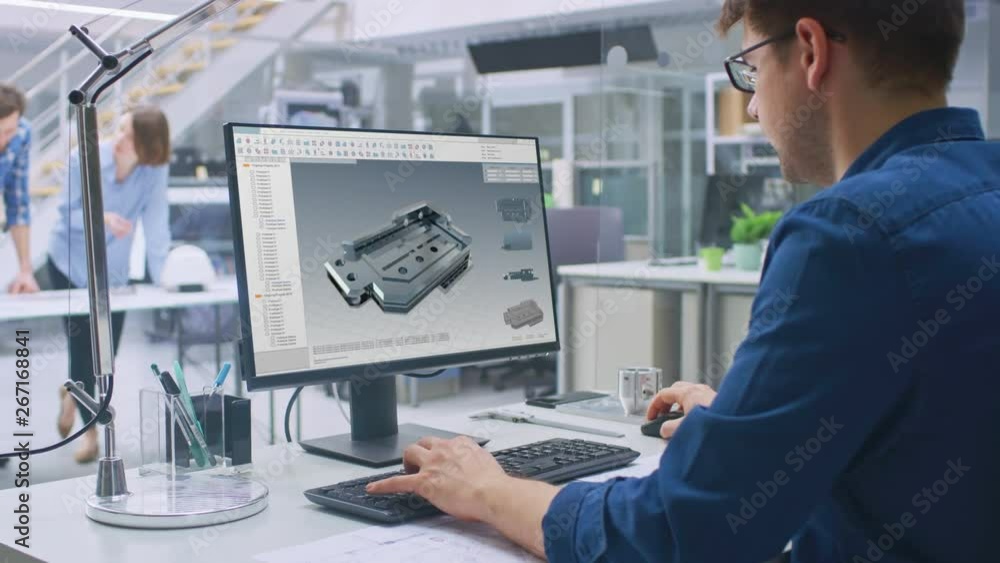 Poster Engineer Working on Desktop Computer, Screen Showing CAD Software with 3D Component. In the Background Engineering Facility with Blueprints and Drawings with Industrial Design. Over the Shoulder
