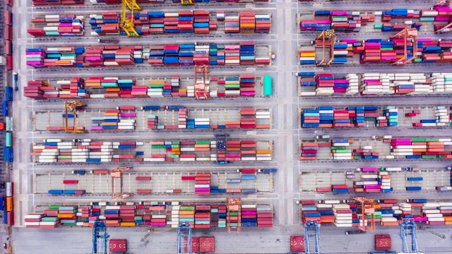 4k Hyperlapse aerial view container ship loading and unloading in deep sea port, Aerial top view of logistic import export transportation business by container ship in open sea.