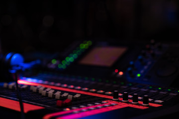 Fototapeta na wymiar Audio mixing console with colourful tape markings in dim lightning in a concert venue