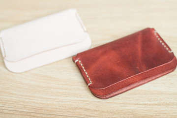 Red brown leather card holder on wood