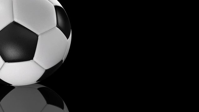 3D animation of textured soccer ball rotating on mirror surface.