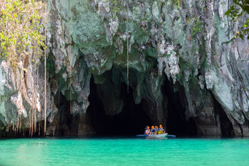 Palawan, Philippines - May 3, 2019: A boat with tourists at the entrance to the underground river...
