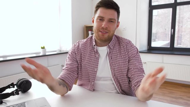 blogging, videoblog and people concept - male blogger recording video blog at home