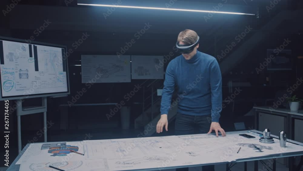 Aufkleber Software Development Engineer Wearing Virtual Reality Headset Gestures and Manipulates Components in Augmented Reality. Engineering Facility Has Desk with Engine and Car Concept Blueprints