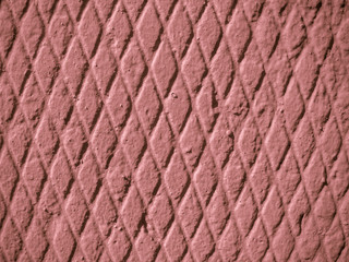 Structured background. Texture - concrete wall, small symmetrical rhombus. Primary color - Coral Tree.