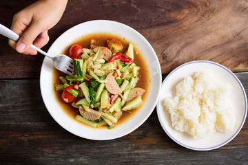 Spicy cucumber salad with steamed pork sausage and sticky rice, Thai food