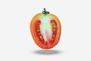 Art of tomato. a half of tomato, slice tomato, fly tomato isolated on white