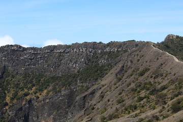 the clear sky above the volcanic crater that surrounds the clouds