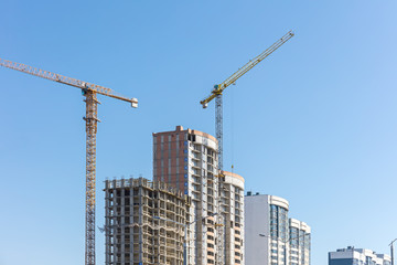 Fototapeta na wymiar urban construction site against clear blue sky background
