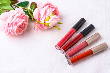 Obraz na płótnie Canvas Cosmetics,makeup lipstics products with pink rose
