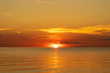 Fototapeta na wymiar Colorful sunset over calm sea water near tropical beach. Summer vacation concept. Island Phangan, Thailand