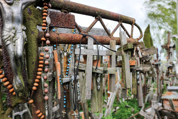 Wooden crosses on large rusty iron cross closeup
