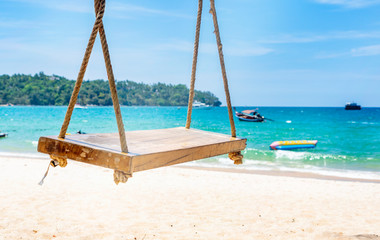 empty rope swing at summer beach day.Joy life freedom holidays for honeymoon concept