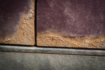Rust spots on burgundy color car