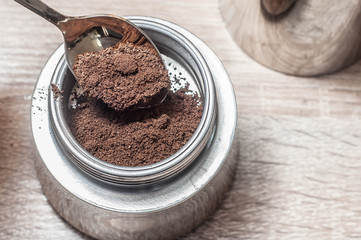 Nasty tones. Spilled coffee in a coffee maker on a wooden table for morning exercise