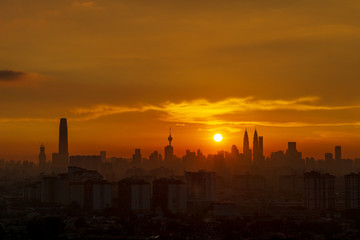 Fototapeta na wymiar Majestic sunset over downtown Kuala Lumpur, a capital of Malaysia. Its modern skyline is dominated by the 451m-tall Petronas Twin Towers.