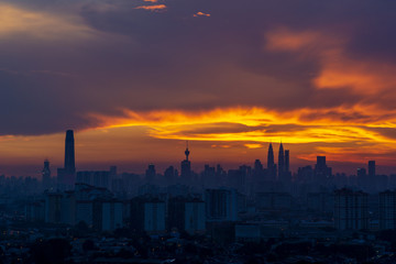 Fototapeta na wymiar Majestic sunset over downtown Kuala Lumpur, a capital of Malaysia. Its modern skyline is dominated by the 451m-tall Petronas Twin Towers.