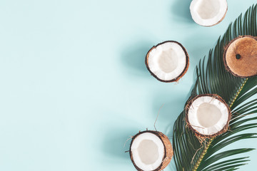 Summer composition. Coconut, palm leaf on pastel blue background. Summer concept. Flat lay, top view, copy space