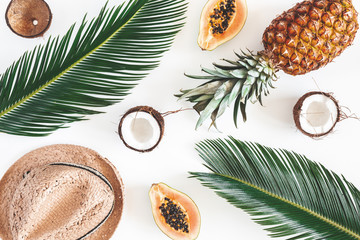 Summer composition. Tropical palm leaves, hat, coconut, pineapple, papaya on white background....