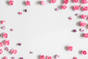 Flowers composition. Frame made of purple and pink flowers on pastel gray background. Flat lay, top view, copy space