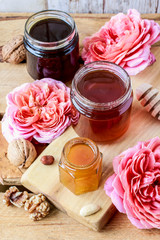Honey in glass jar on wooden background