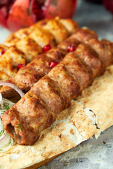 Plates of meat with barbecue and kebab, on gray background