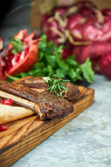 Wooden board with meat from a barbecue,