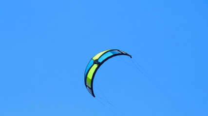 Cplorful kite-surfing kite against clear blue sky