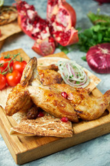 Grilled chicken on a wooden board with vegetables 