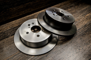 Car brake diske on wooden background