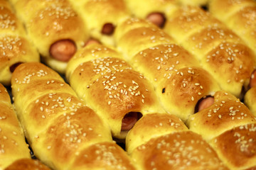 Fresh tasty sausages in dough close up
