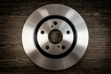 Car brake diske on wooden background