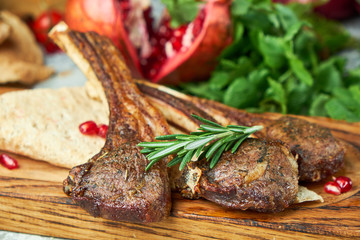 Wooden board with meat from a barbecue,