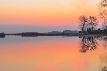 Fototapeta na wymiar Biebrza Valley (Poland). Backwaters near Goniadz town with birds in background at dusk