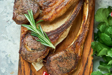 Wooden board with meat from a barbecue,