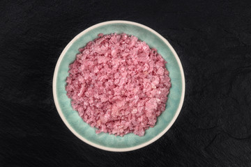 Pink Himalayan sea salt, shot from the top on a dark background with a place for text