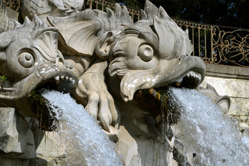 Fototapeta na wymiar The sculptures of the Three Dolphins fountain in Caserta close-up.